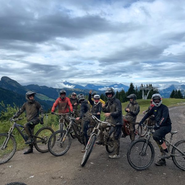 Club riders at the top of a Morzine descent in the Alps